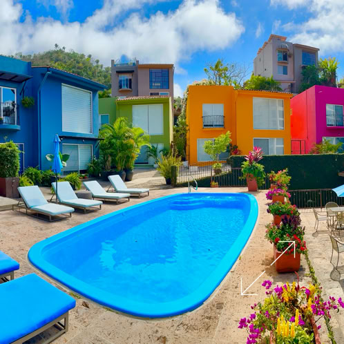 Stylish industrial-style living room featuring a leather sofa, rustic brick wall, and indoor plants.